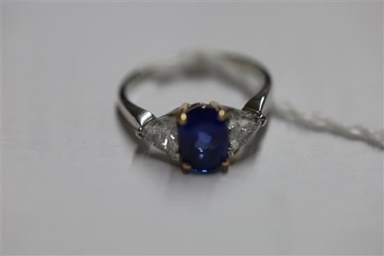 A modern 18ct white gold sapphire and diamond three stone dress ring, size M.